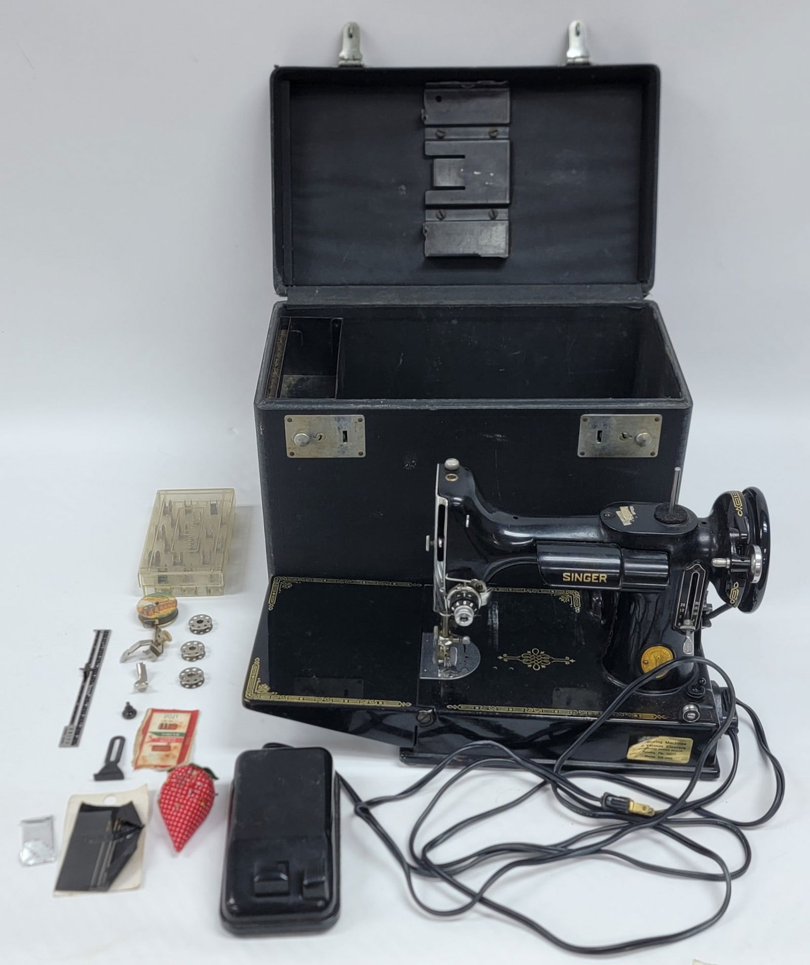 Vintage Singer Featherweight Model 221 Sewing Machine: Vintage Singer Featherweight Model 221 Sewing Machine. The machine is in nice used working condition with some accessories. It comes in the case. Case measures 11" tall x 14-1/2" across x 8-1/4" deep