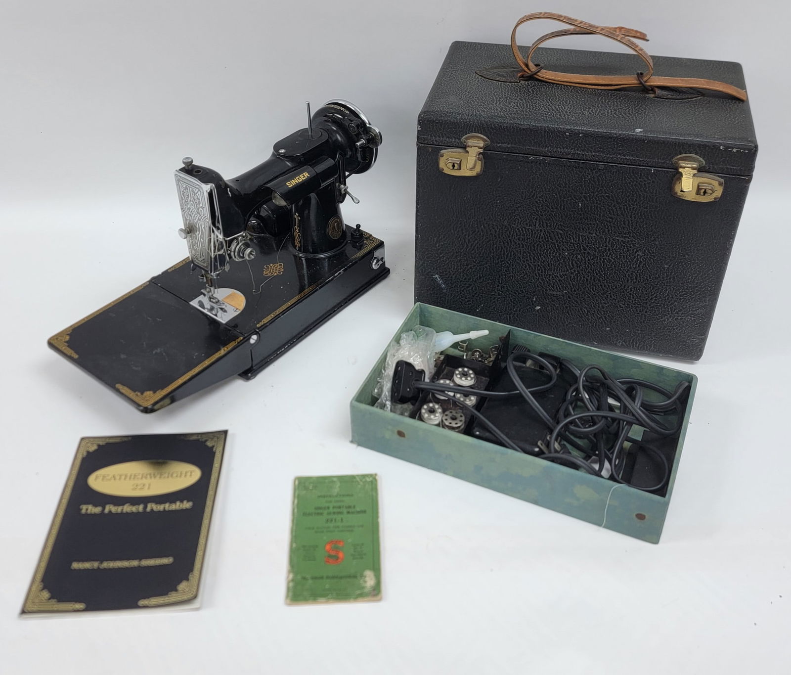 Vintage Singer Featherweight Model 221-1 Sewing Machine: Vintage Singer Featherweight Model 221-1 Sewing Machine. The machine is in nice used working condition with the instructions and accessories, has two bobbin cases. It comes in the case with tray, case