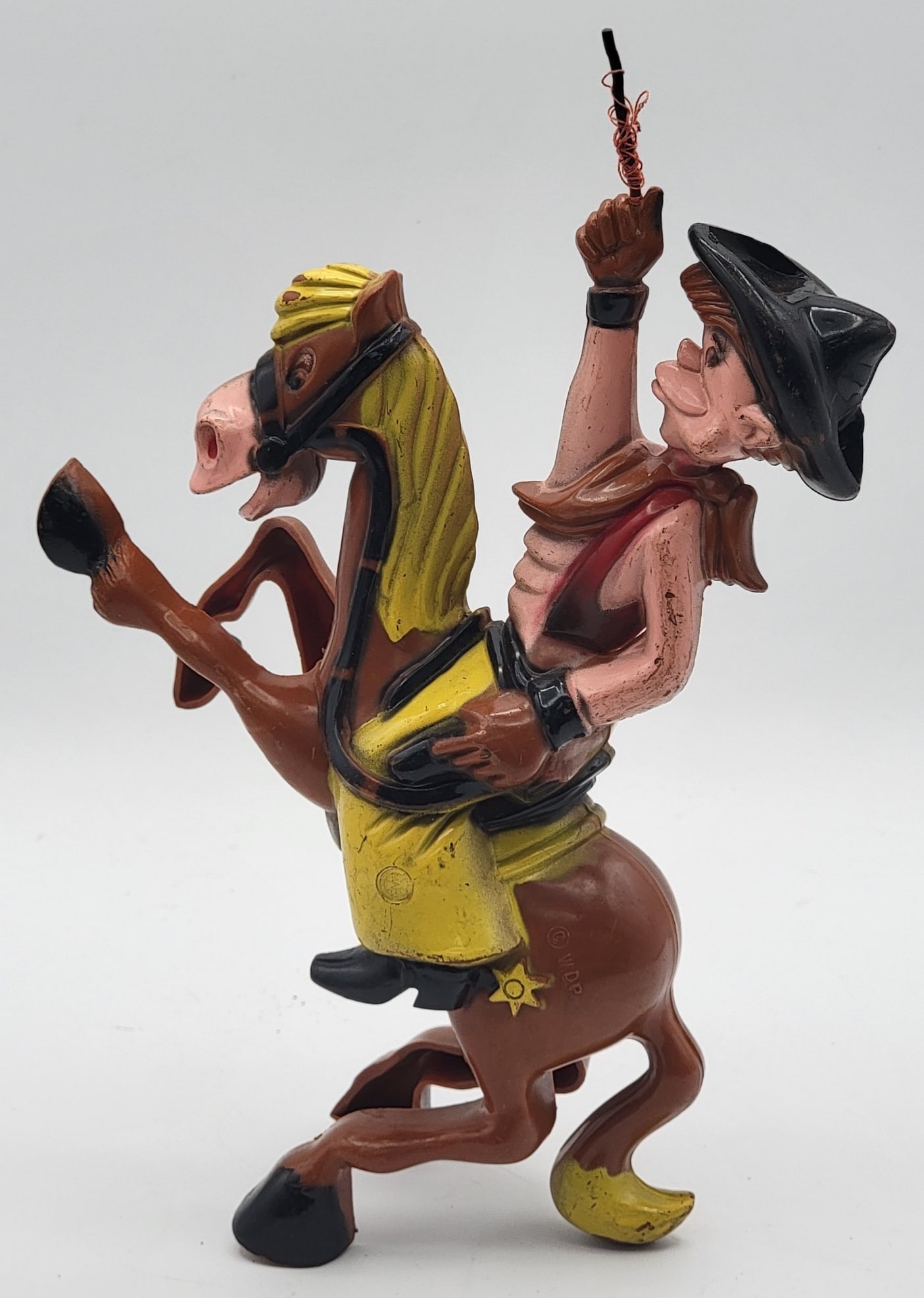 Vintage Walt Disney Productions "Pecos Bill" Wind-Up Toy: Vintage Walt Disney Productions "Pecos Bill" Wind-Up Toy. The plastic toy features Pecos Bill riding Widowmaker. The toy works, but is missing the lasso, shows some play wear. Measures 9-5/8" tall.