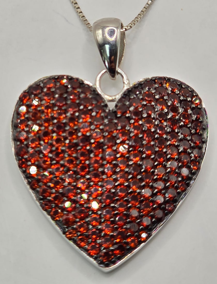 Ladies Sterling Silver Red Garnet Cluster Heart Pendant & Chain: Ladies Sterling Silver Red Garnet Cluster Heart Pendant & Chain. The pendant measures 1-1/4" tall x 1-1/8" across, the chain measures 18" long. Total weight is 12 grams.