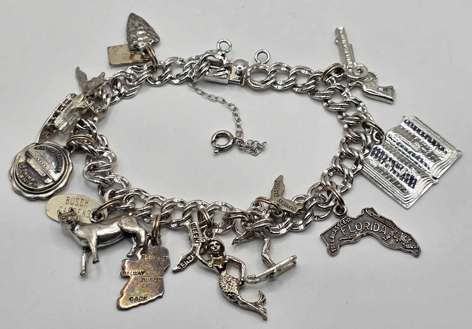 Vintage Elco Sterling Silver Charm Bracelet With Ten Charms: Vintage Elco Sterling Silver Charm Bracelet With Ten Charms. Half the charms are sterling and the other half are nickel silver. The bracelet measures 6-3/4" long and the total weight is 31.18 grams.