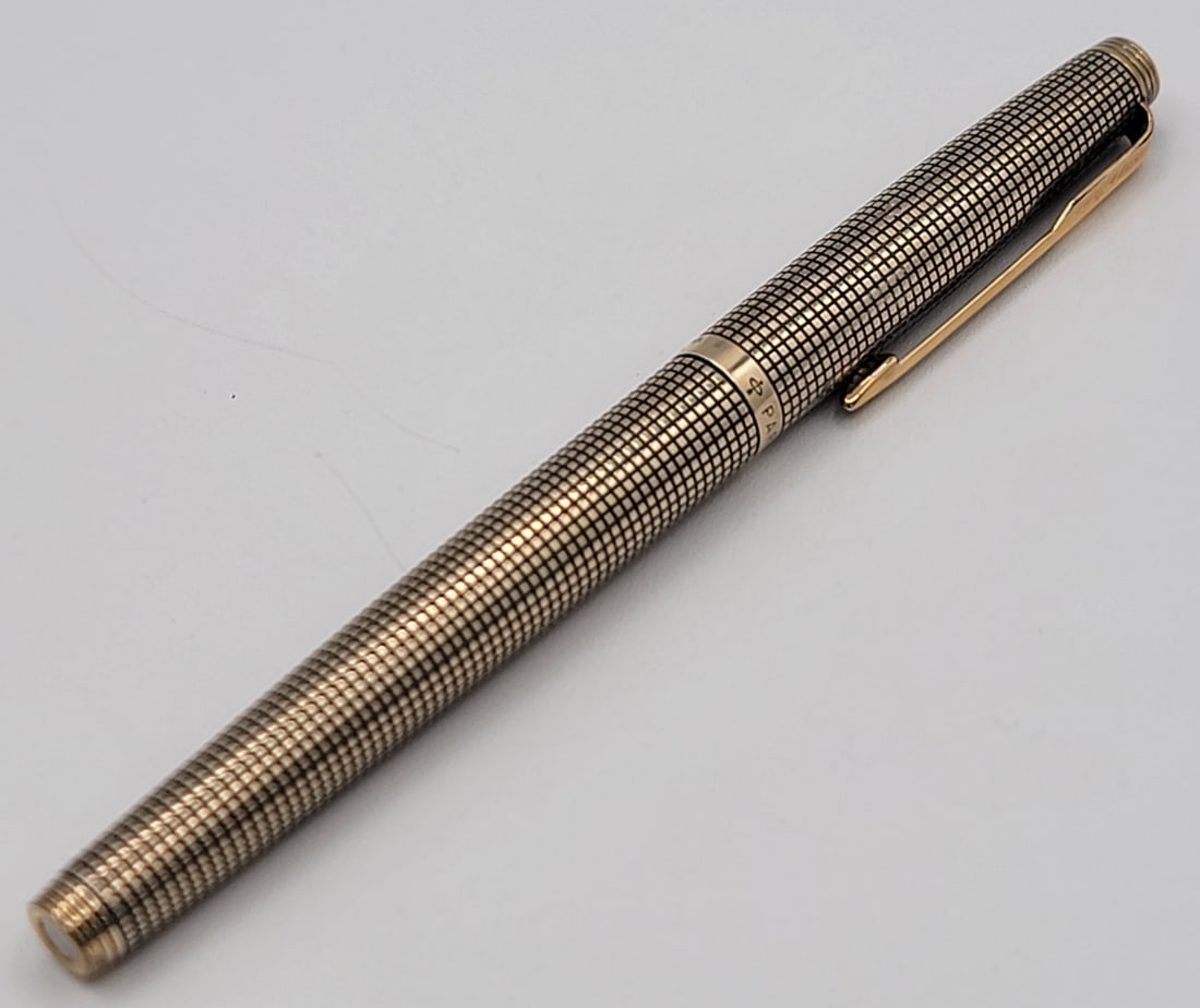 Vintage Parker 75 Cisele Sterling Silver Gold Plated Fountain Pen: Vintage Parker 75 Cisele Sterling Silver Gold Plated Fountain Pen. The pen appears to be in nice condition with a 18k gold nib. Overall the pen measures 5-1/8" long.