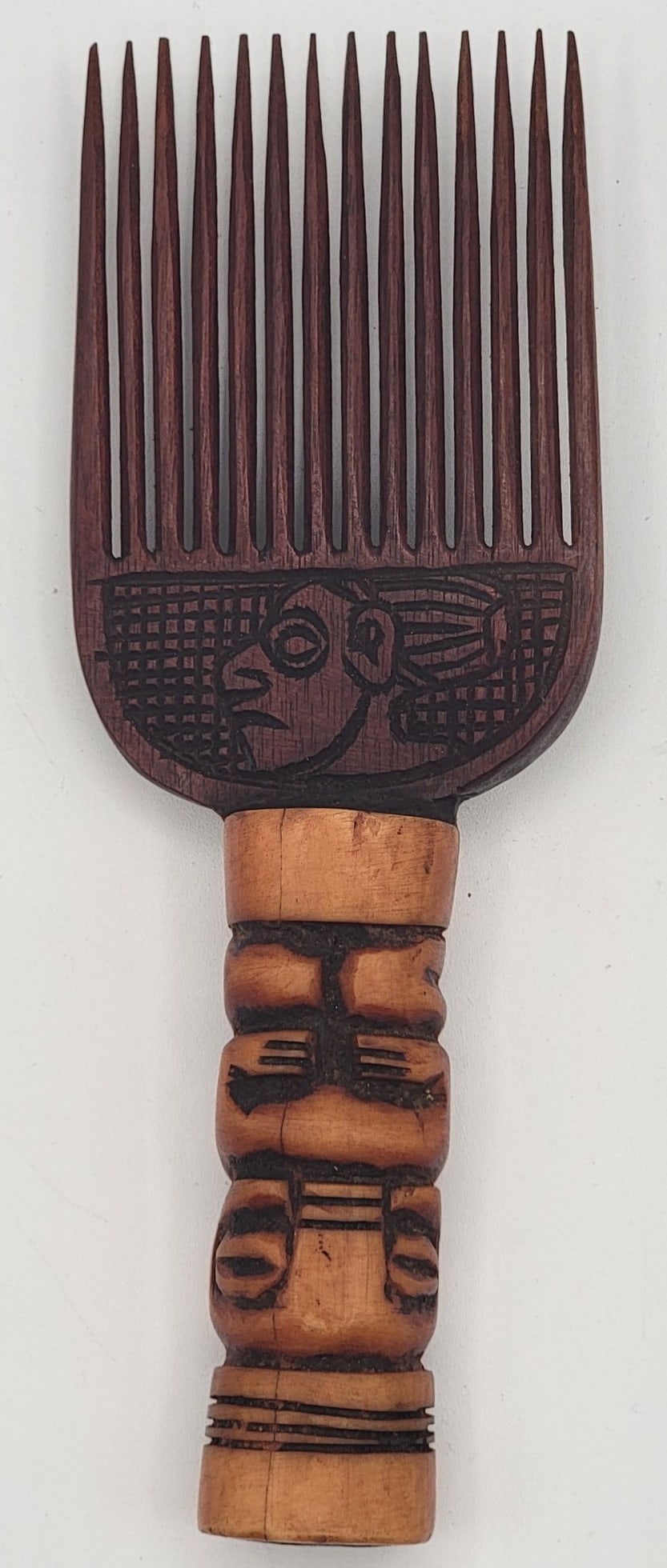Vintage African Tribal Carved Wood & Bone Comb: Vintage African Tribal Carved Wood & Bone Comb. The handle is carved bone and the teeth are carved wood. Very nice condition with great workmanship. Measures 8" tall x 2-3/4" across.