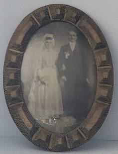 Antique Wedding Photograph In Oval Curved Glass Tramp Art Frame: Antique Wedding Photograph In Oval Curved Glass Tramp Art Frame. The wood frame has a gold finish and is in nice condition. Overall measures 25" tall x 18-1/2" across.