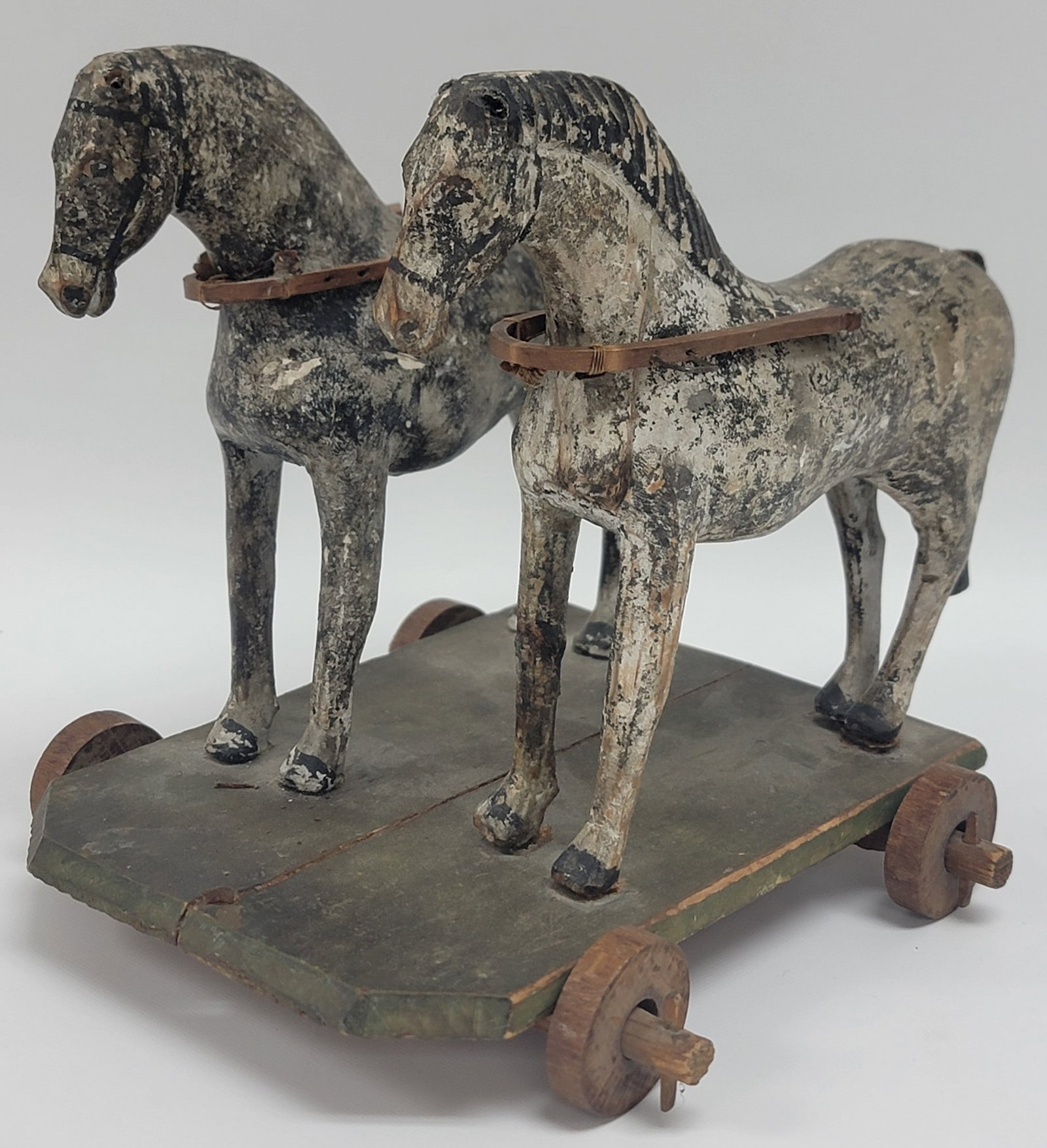 Antique Folk Art Carved & Painted Wood Horses Pull Toy: Antique Folk Art Carved & Painted Wood Horses Pull Toy. The polychrome toy is in good condition with some age and play wear, missing the pull string. Measures 7-1/2" tall x 7-1/2" across x 7" deep.