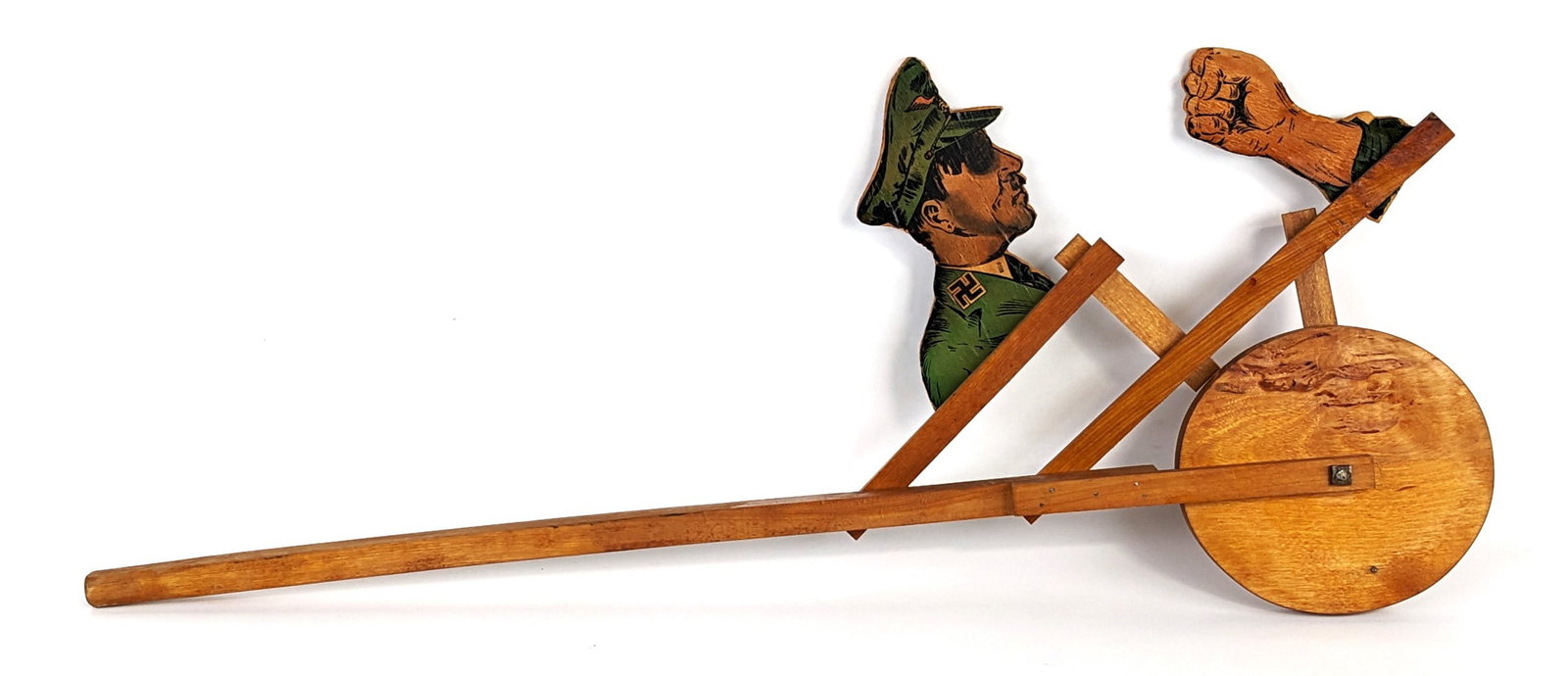 Wooden Anti-Hitler Push Toy: Unique vintage anti-Hitler wooden push toy. A paper lithograph depicts Hitler punching himself when the toy is pushed. The toy is in working condition. Measures approximately 32-1/2" long.