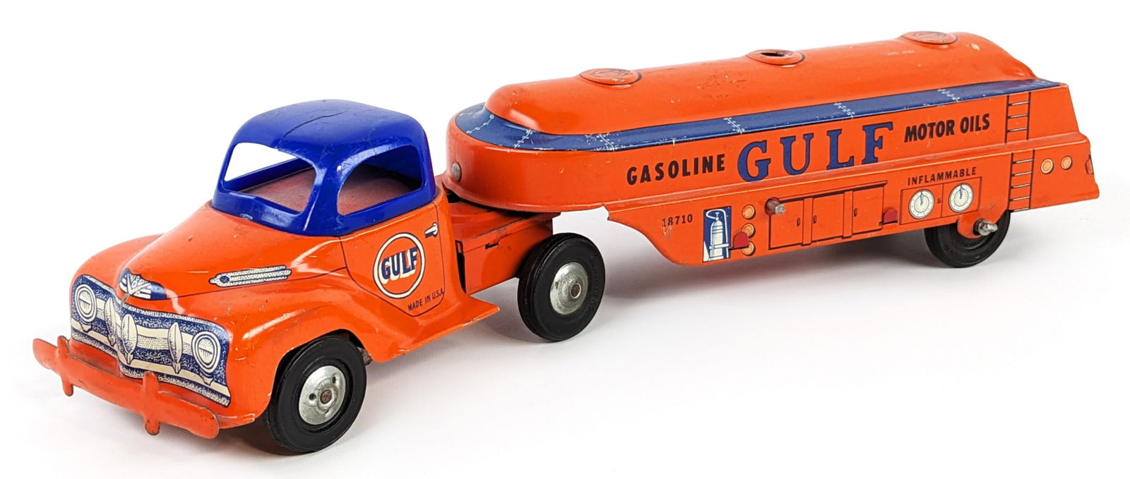 Courtland Tin Friction Gulf Gasoline Tanker Truck: Courtland tin friction Gulf Gasoline tanker truck. The truck has a crack in the plastic roof, some paint loss, and wear from play / age. The friction mechanism works. Measures approximately 13" long.