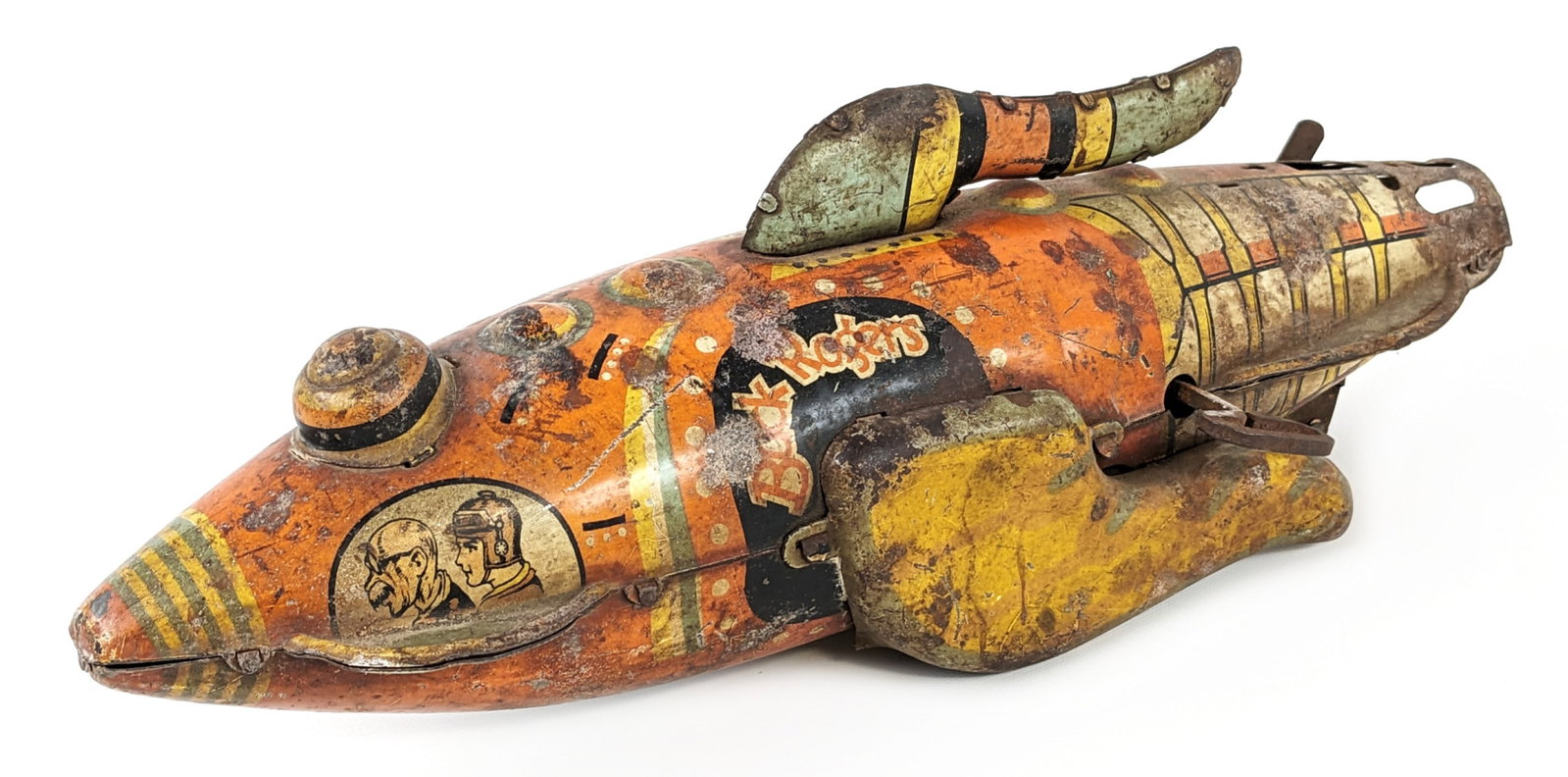 Marx Tin Windup Buck Rogers Rocket Ship: Marx tin windup Buck Rogers rocket ship. The ship is in fairly rough condition with discoloration, paint loss, and excessive play wear. The windup mechanism still works, but only when held in the air.
