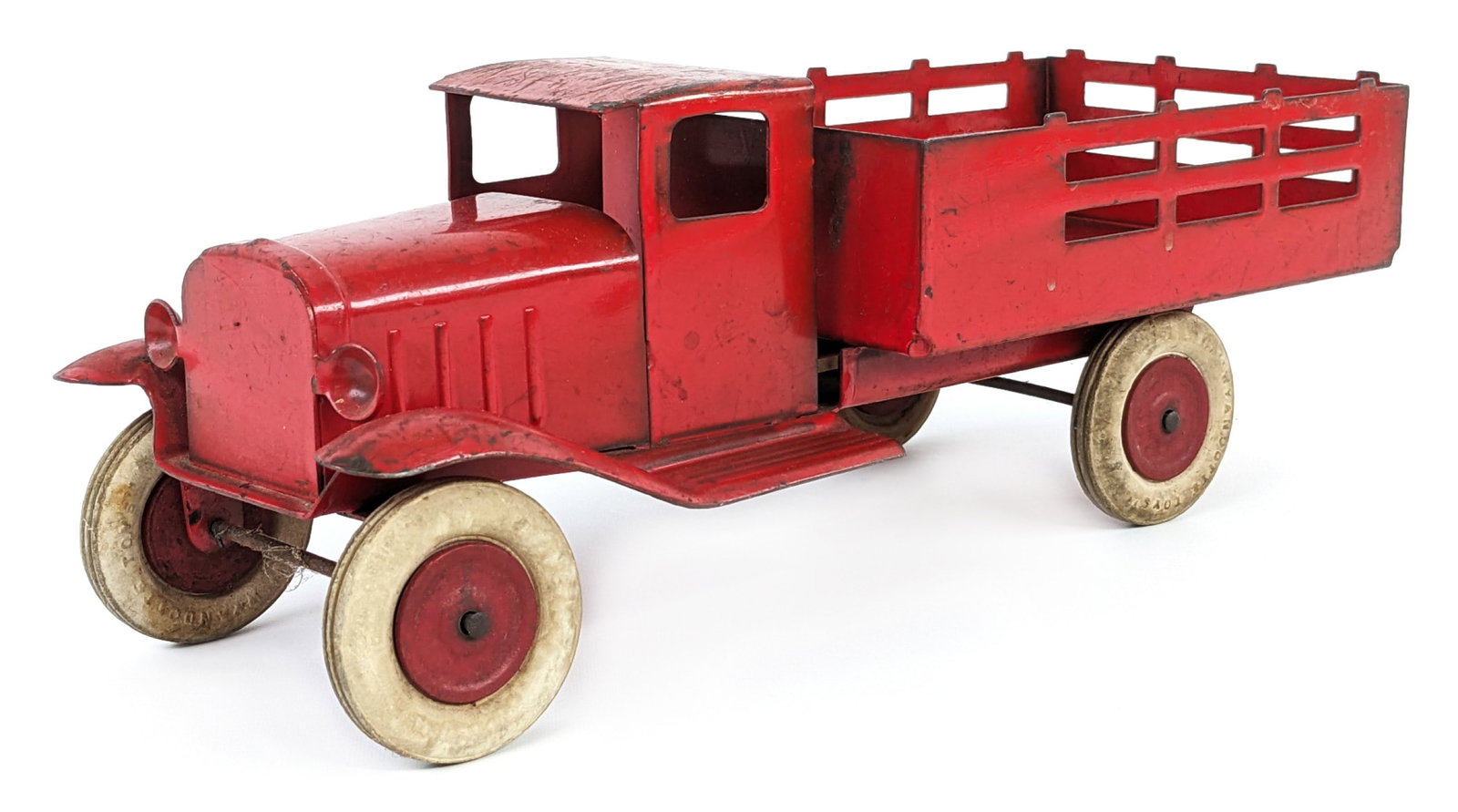 Original 12" Wyandotte Stake Bed Truck: Original Wyandotte stake bed truck. The truck has paint loss and wear from play / age. Measures approximately 12" long.
