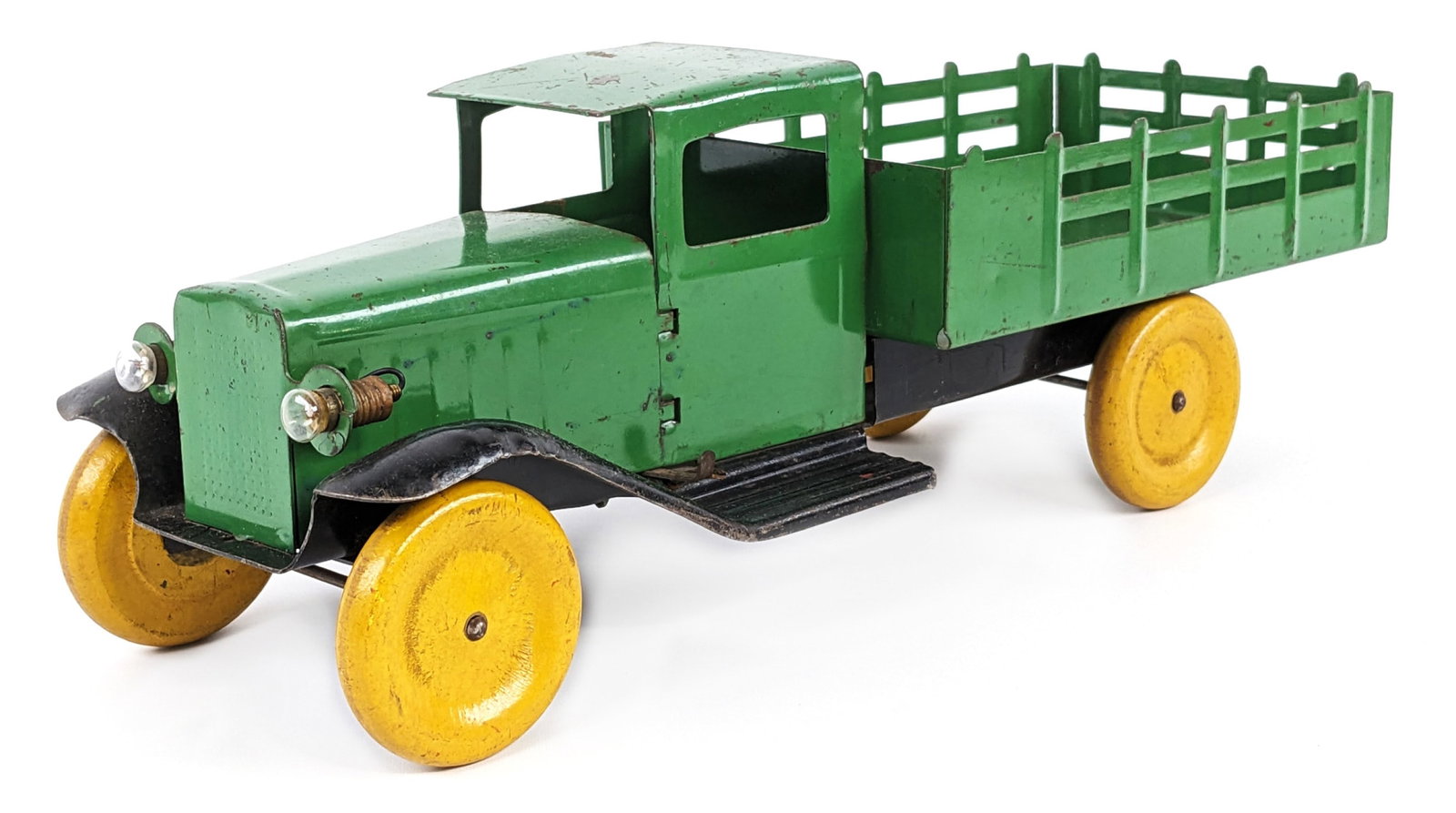 Original 15" Wyandotte Stake Bed Truck w/ Electric Headlights: Original Wyandotte stake bed truck with electric headlights. The truck has some paint loss and wear from play / age. Displays well with electric headlights. Measures approximately 15" long.