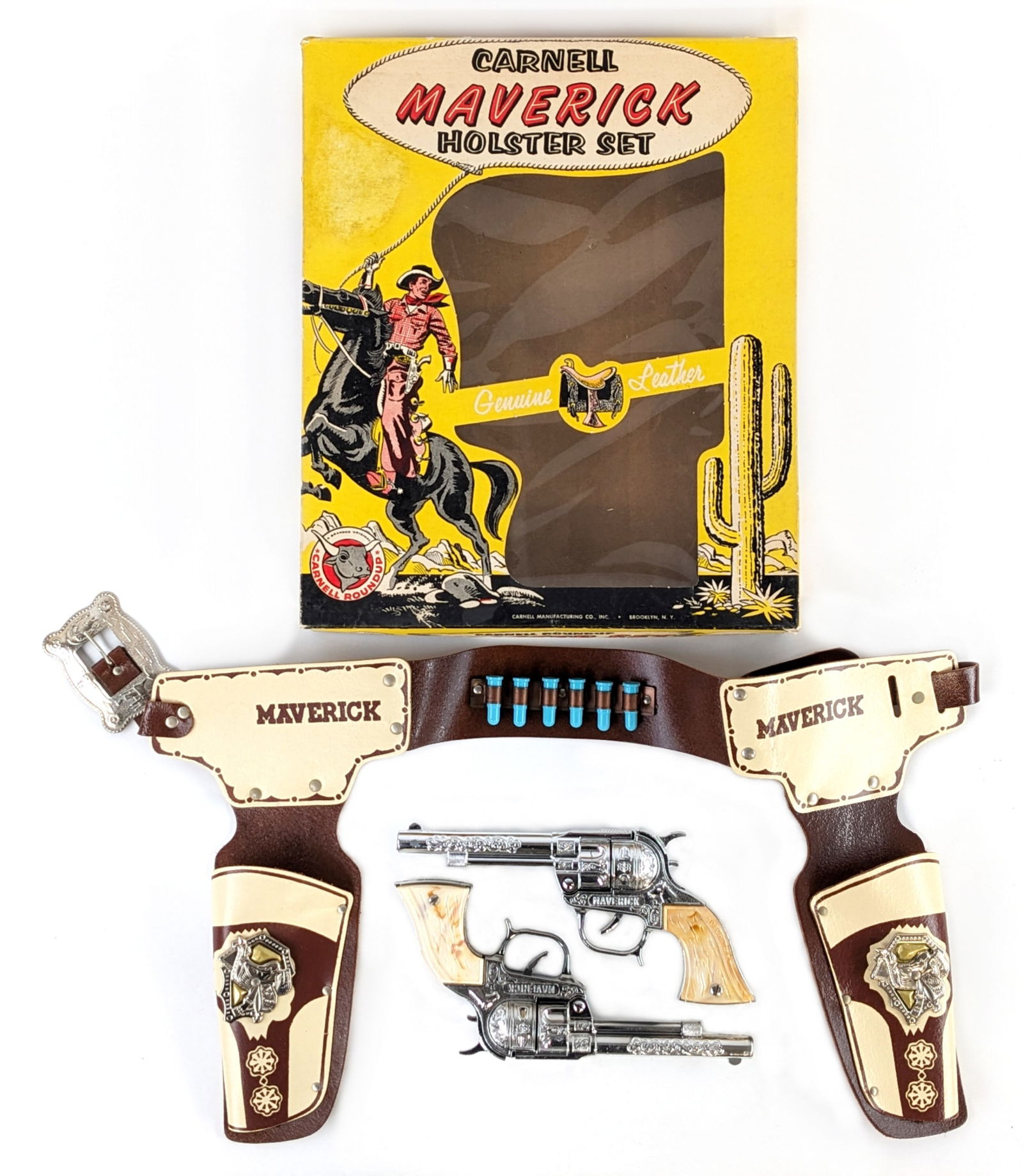 Carnell Manufacturing Maverick Cap Gun Holster Set In Box: Carnell Manufacturing Co. Maverick cap gun holster set in the original box. The set includes two Maverick cap guns, six blue rubber bullets, and a genuine leather dual holster. The set is in excellent