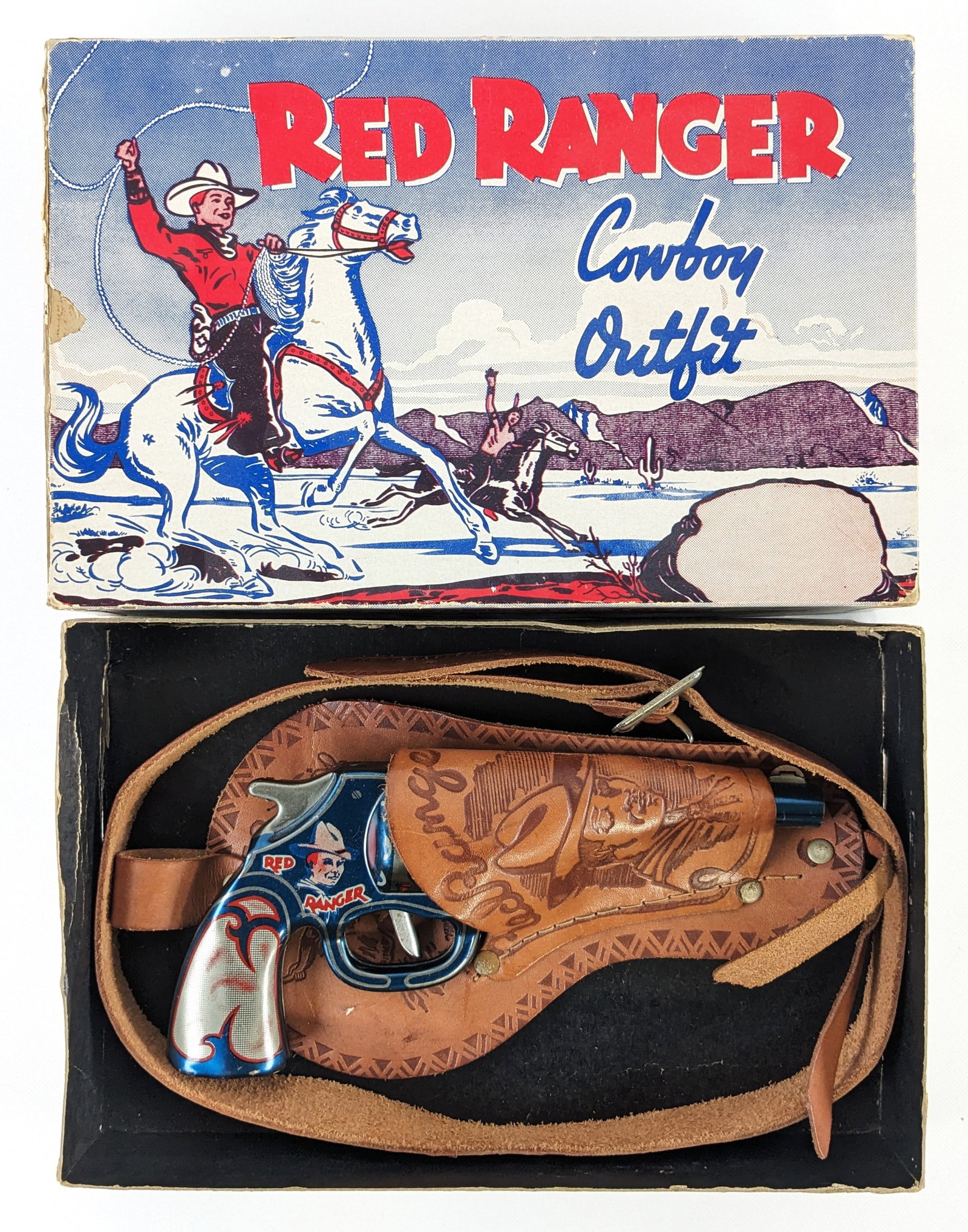 Wyandotte Toys Red Ranger Cowboy Outfit w/ Gun In Original Box: Wyandotte Toys Red Ranger Cowboy Outfit in original box. Includes a tin clicker gun and leather holster. The box tray has some tape repairs and the lid has some edge wear and small tears. Overall an e