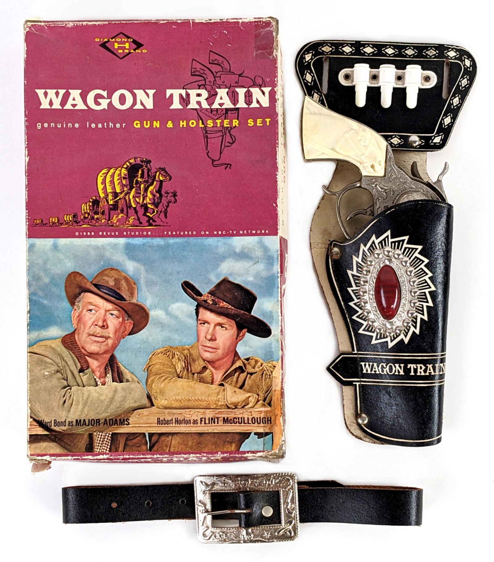 Leslie Henry Wagon Train Cap Gun & Holster Set In Box: Leslie Henry Wagon Train cap gun and single holster set in the original box. The gun shows minor oxidation and minor oxidation to the buttons on the holster. The box tray has a tear and the lid shows