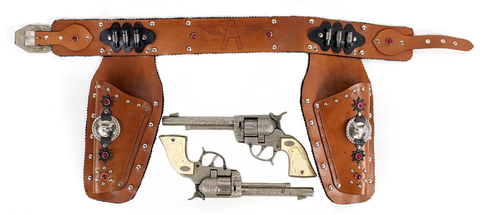 Leslie-Henry Gene Autry .44 Cap Gun Set With Leather Holster: Leslie-Henry Gene Autry .44 cap gun set with dual leather holster. The holster is in excellent condition with light wear from storage / age. The guns have some yellowing to the grips and minor cracks.