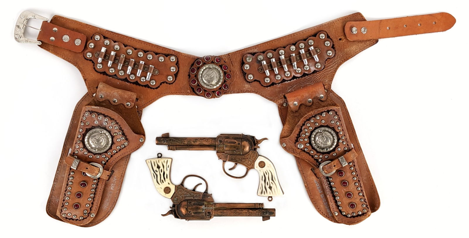 Actoy Lone Ranger Cap Guns w/ Leather Holster: Actoy Lone Ranger cap gun set with Esquire dual holster. The cap guns have some plate loss and wear from age. The leather holster shows some discoloration and wear from age. It has all the bullets. Th