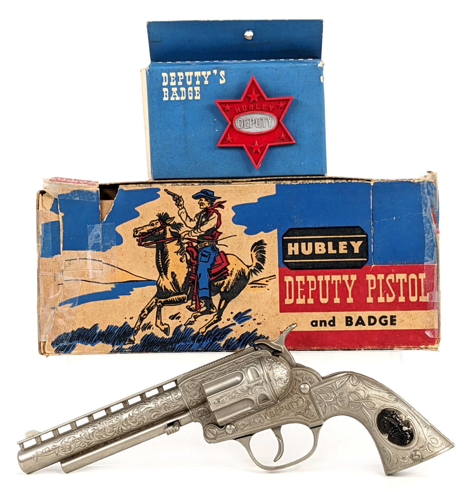 Hubley Deputy Cap Gun w/ Badge In Box: Hubley Deputy cap gun pistol with Deputy badge and the original box. The box has tape repairs, tearing, and missing pieces from handling / age. The cap gun is in very good condition and works as it sh