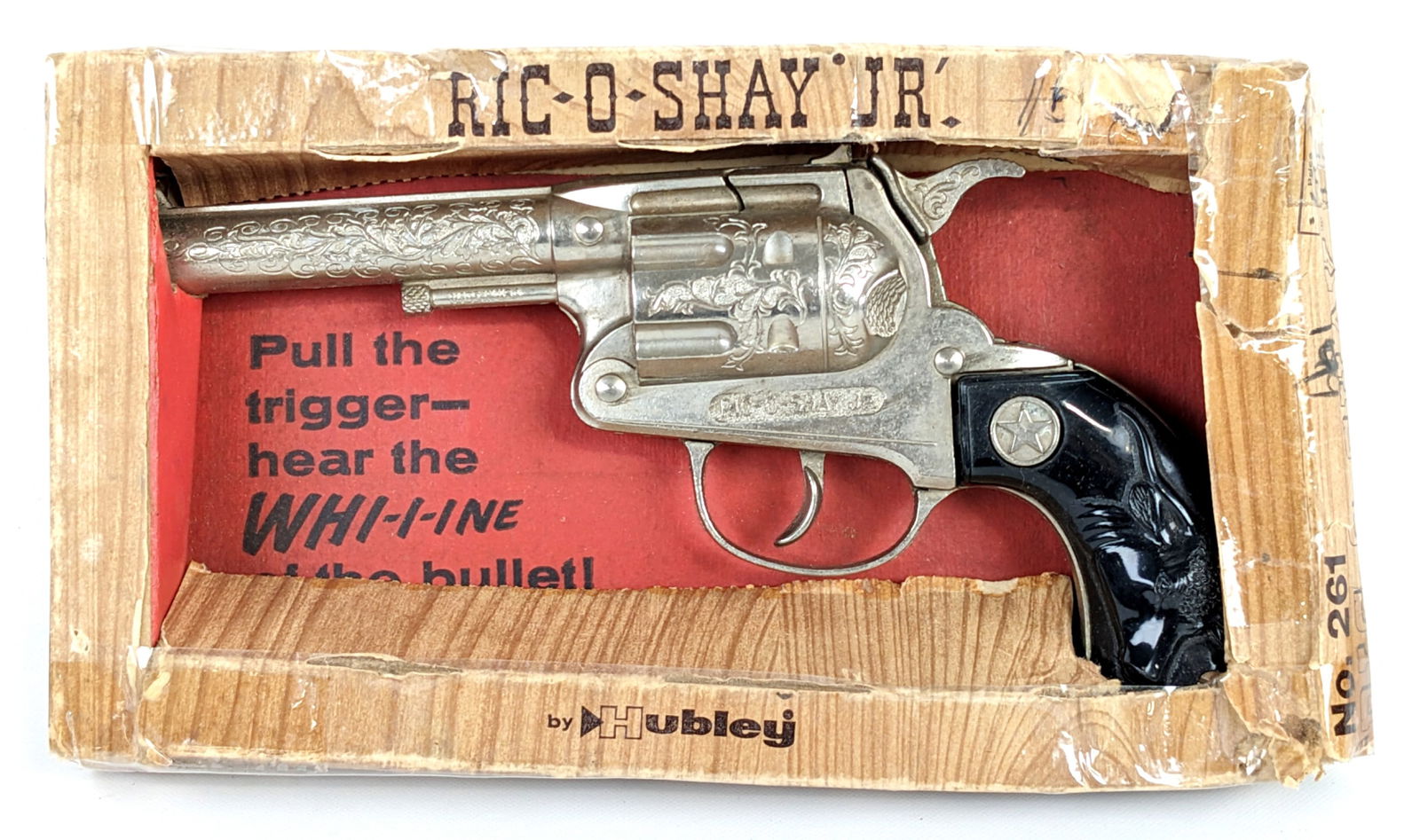 Hubley Ric-O-Shay Jr. Cap Gun w/ Box: Hubley Ric-O-Shay Jr. 50 shot repeater cap gun with the original box. The cap gun has a tiny chip in the left side grip. The gun is in good working condition. The box has tape, crushing, and wear / te