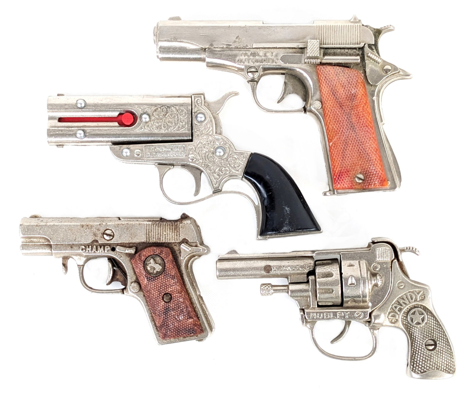 Hubley Dandy, Champ, Dagger Derringer, & Automatic Cap Gun Pistols: (4) Hubley cap pistols guns. The guns includes a Police .38 Dandu revolver, Dagger Derringer, Champ, and Hubley Automatic. All are in working order with some light use wear. Largest measures 6-1/2" ac
