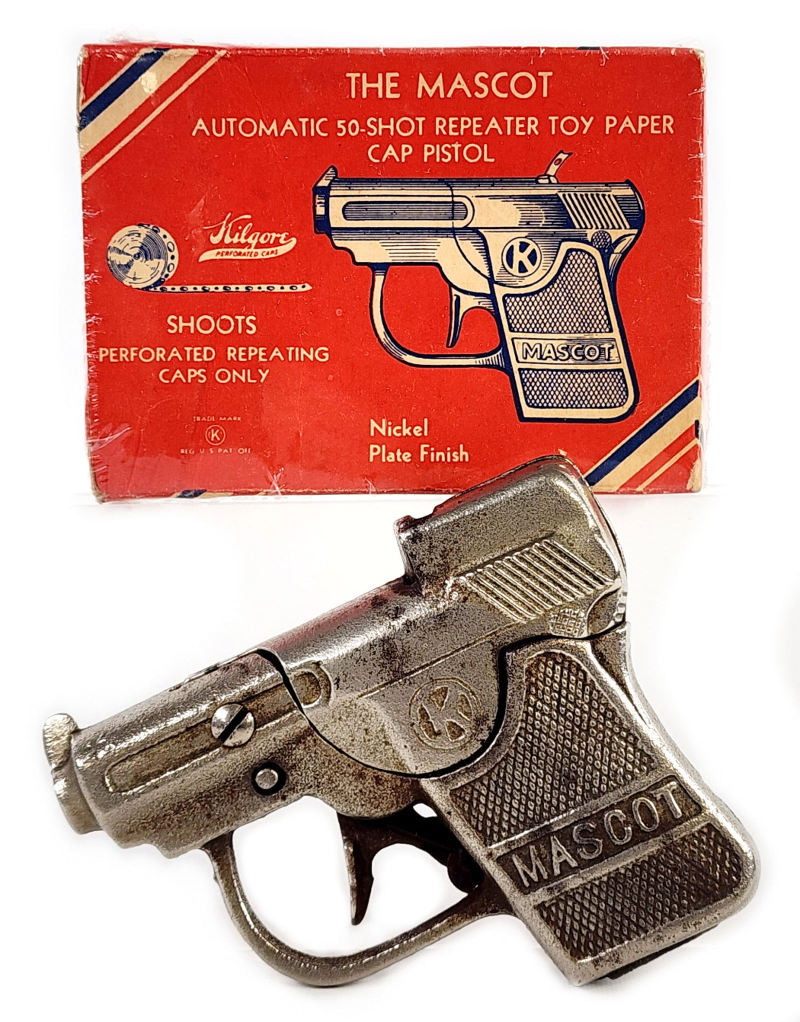 Kilgore Mascot Cap Gun Pistol w/ Box: Kilgore "The Mascot" cap gun pistol with the original box. The gun shows some loss to the nickel plate finish. The box has some wrinkling and age wear. The box was wrapped in plastic to help preserve