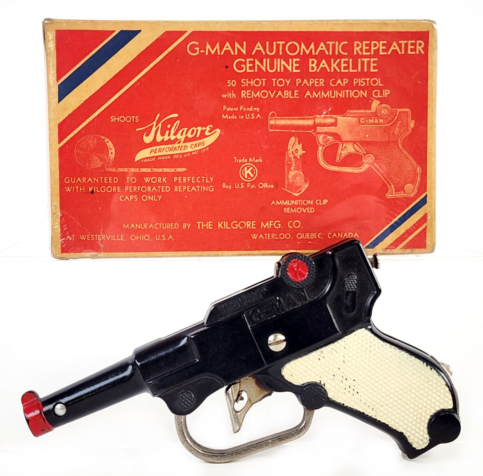 Kilgore G-Man Bakelite Cap Gun Pistol w/ White Grips In Box: Kilgore G-Man automatic repeater genuine bakelite cap gun pistol with white grips and the original box. The gun is in very good working condition with light wear from use. The box was wrapped in plast