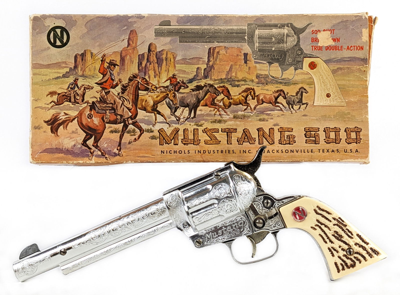 Nichols Mustang 500 Cap Gun Pistol w/ Box: Nichols Mustang 500 cap gun pistol with the original box. The gun appears to be in good working condition. The box has some wear / tear to the end flaps, but appears to be complete. A nice example of