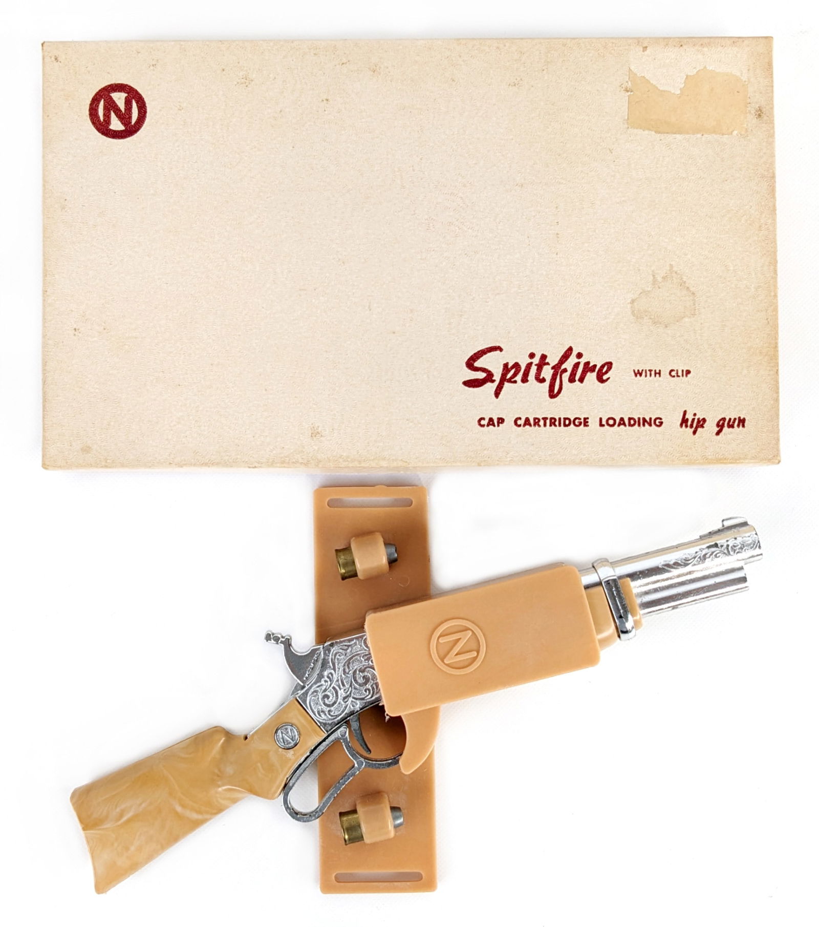 Nichols Spitfire Cap Gun w/ Clip In Box: Nichols Spitfire cap gun in original box. The cap gun comes complete with the clip and cartridges. The box has some peeling on the lid and staining. Appears to be in working order. Overall very nice c