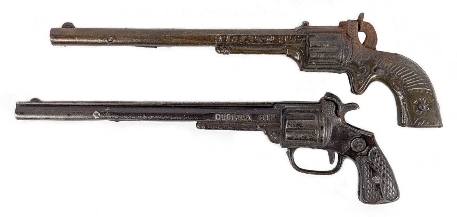 (2) Early Stevens Buffalo Bill Cap Gun Pistols: Includes a circa 1890's Stevens Buffalo Bill tilt gun. When you tilt the gun down at an angle it reads "Buffalo Bill". Also includes a circa 1923 Stevens Buffalo Bill cap gun. Both are single shots an