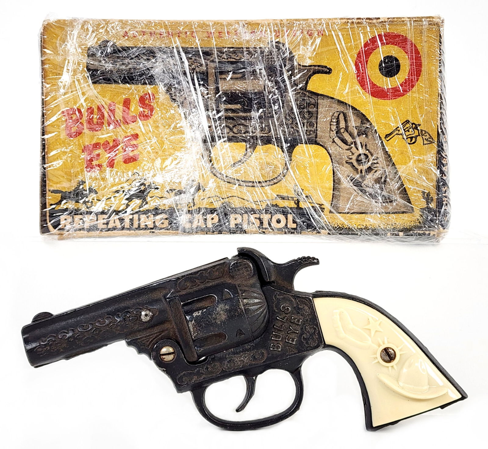 Kenton Bulls Eye Cap Gun Pistol w/ Box: Kenton Bulls Eye cap gun pistol with original box. The gun has some oxidation and light wear from use / age. It appears to work as it should. The box is in rough condition and is missing most of the f