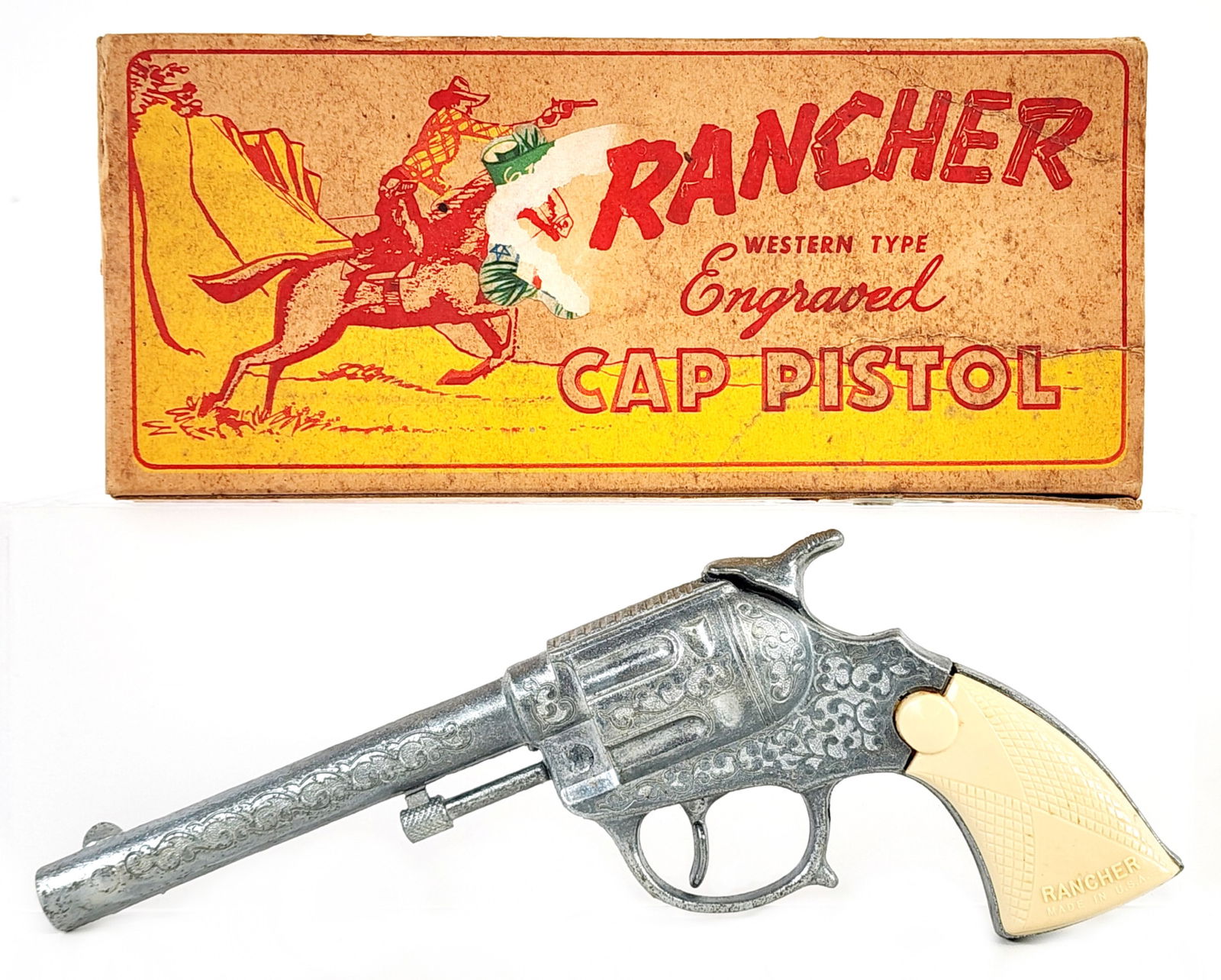 Wyandotte Rancher Cap Gun Pistol w/ Box: Wyandotte Rancher engraved cap gun pistol with the original box. The pistol is in excellent condition with some light age wear. The box has loose end flaps, soiling, and wear from storage / age. Measu