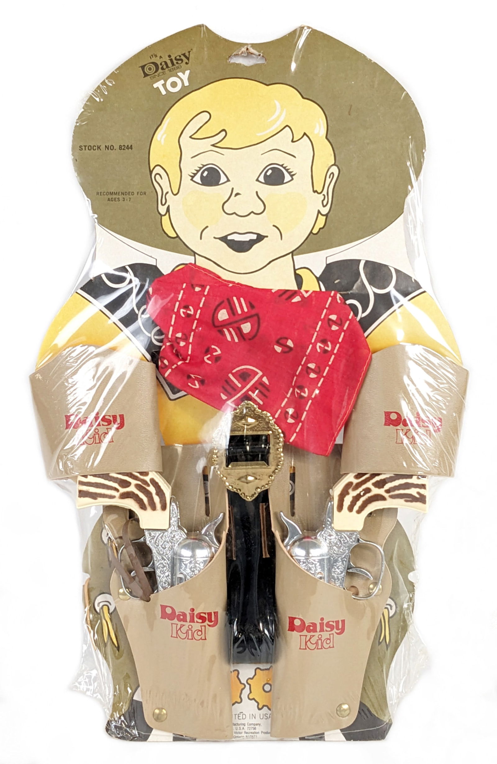 Daisy Kid Cap Gun Set MOC: Vintage Daisy Kid cap gun set mint on the original card. The set contains a pair of cap guns, holster with belt, cuff links, and handkerchief. The plastic has a small tear on the bottom left corner an