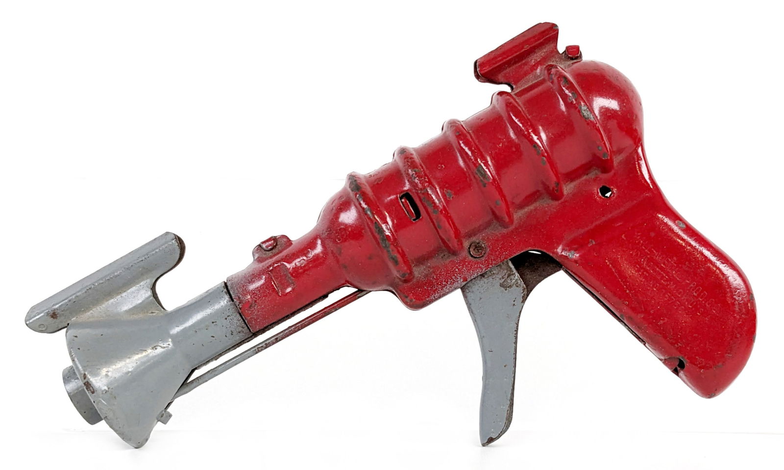 Wyandotte Space Ray Gun: Circa 1930's Wyandotte space ray gun. The gun has some overpaint, corrosion, and wear from play / age. The action appears to work while the trigger is pulled the gun makes a popping sound. Measures 7"