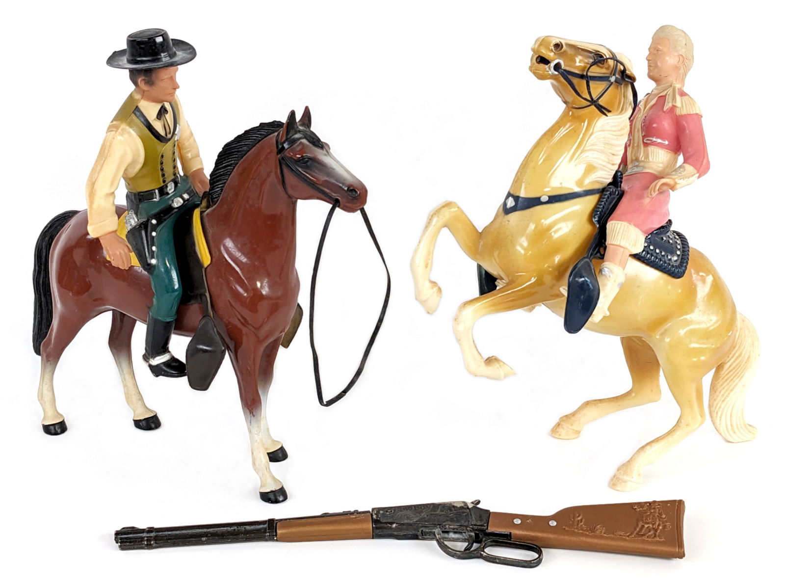 Hartland Annie Oakley & Wyatt Earp Figures w/ Horses: Hartland Annie Oakley and her horse Target + Wyatt Earp and his horse Buck plastic figures. Annie is missing her hat. The figures show some wear from play and age. Also comes with a cowboy lever actio