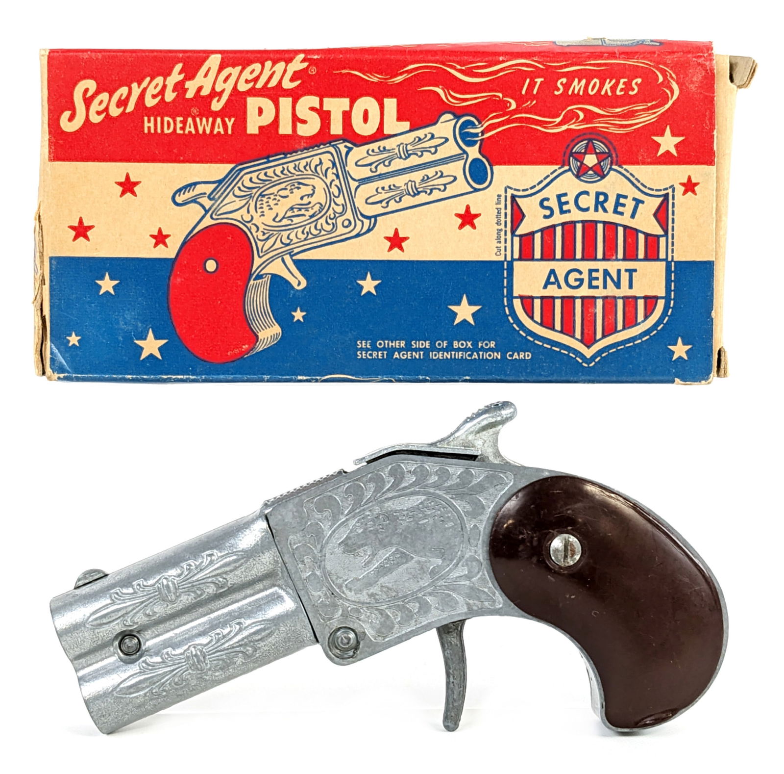 Hamilton Specialties Secret Agent Hideaway Pistol Cap Gun w/ Box: Hamilton Specialties Secret Agent hideaway pistol cap gun with the original box. The cap gun appears to work as it should, but doesn't stay latched very well. The box has one loose small flap and some