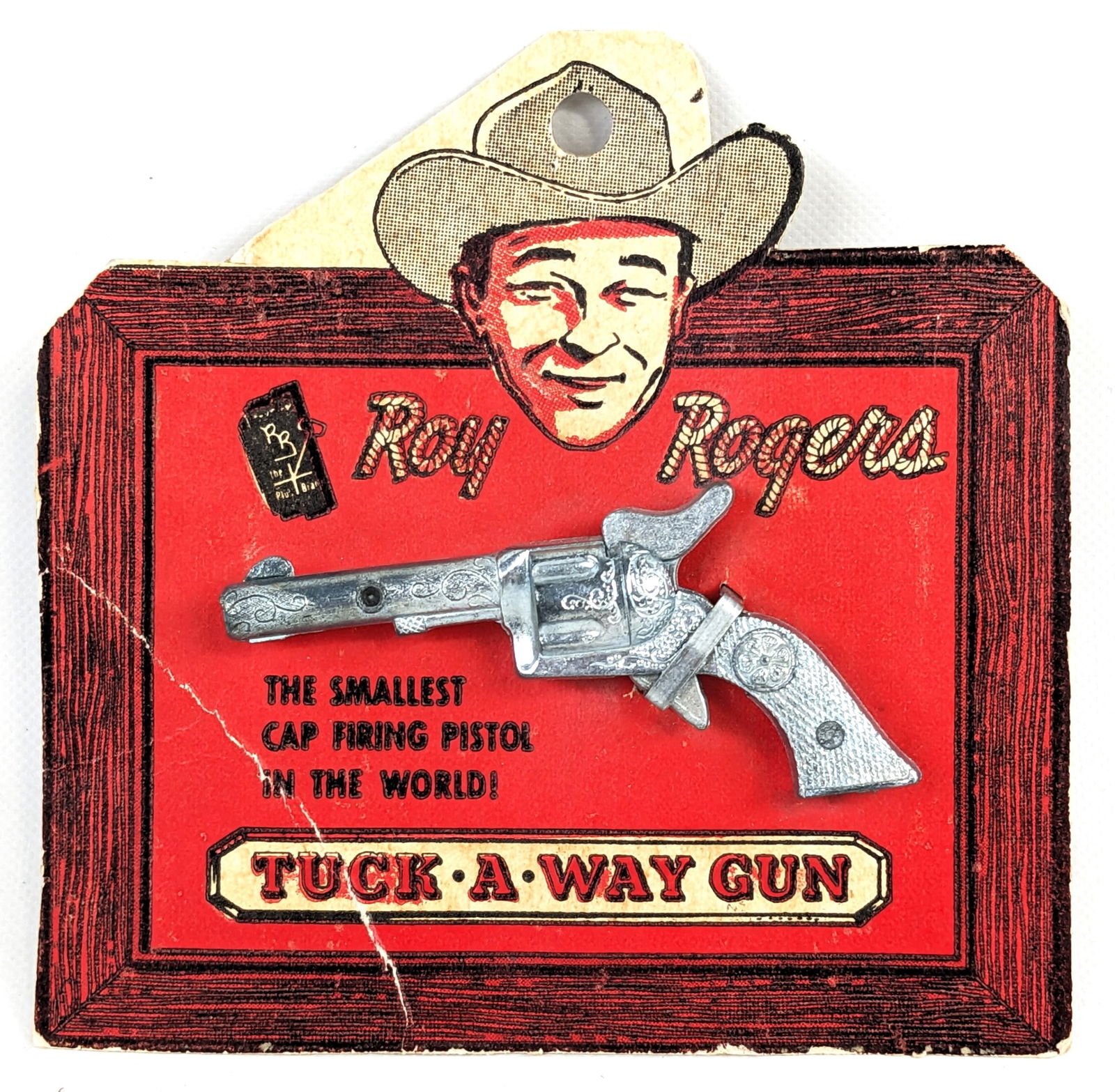 Classy Products Corp. Roy Rogers Tuck-A-Way Cap Gun On Card: Class Products Corp. Roy Rogers Tuck-A-Way cap gun pistol on original card. The cap gun is new in the card and unfired. The card shows creasing and wear around the edges. The gun measures 2-3/4" long.