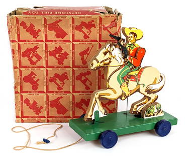 Keystone Shooting Cowboy Pull Toy w/ Box: Keystone Shooting Cowboy wooden pull toy with the original box. The pull tow works the horse makes a galloping motion and makes a popping noise for the guns. The box is missing some end flaps and has