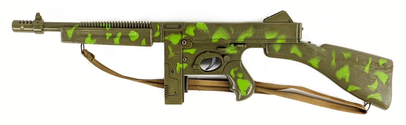 Mattel Tommy Burst Cap Firing Machine Gun: Mattel Tommy Burst cap firing camouflaged machine gun. The gun comes complete with the original sling. The gun is in excellent condition and is in working order. A unique cap gun that is hard to find.