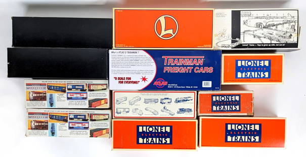 Miscellaneous Boxed O Gauge Train Cars: Lot includes Weaver Ford Hopper Car, Weaver Ford box car, Lionel U.S. Navy flatcar with boat #16939, Lionel caboose #2357, Lionel Ford square window caboose #16557, Lionel 50' U.S. Army box car, Train