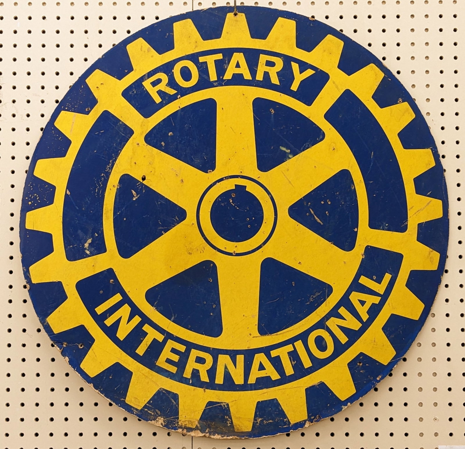 Vintage International Rotary Advertising Sign: Vintage single sided heavy cardboard International Rotary advertising sign. Has paint loss, scratches, some warping, and wear from use and age. Measures approximately 30in in diameter.