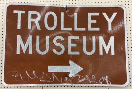 SST Museum Trolley Reflective Directional Street Sign: Single sided metal Museum Trolley reflective directional street sign. Has some decal loss, damage to mounting hole, bend, and other wear from use. Measures approximately 3ft across by 2ft tall.