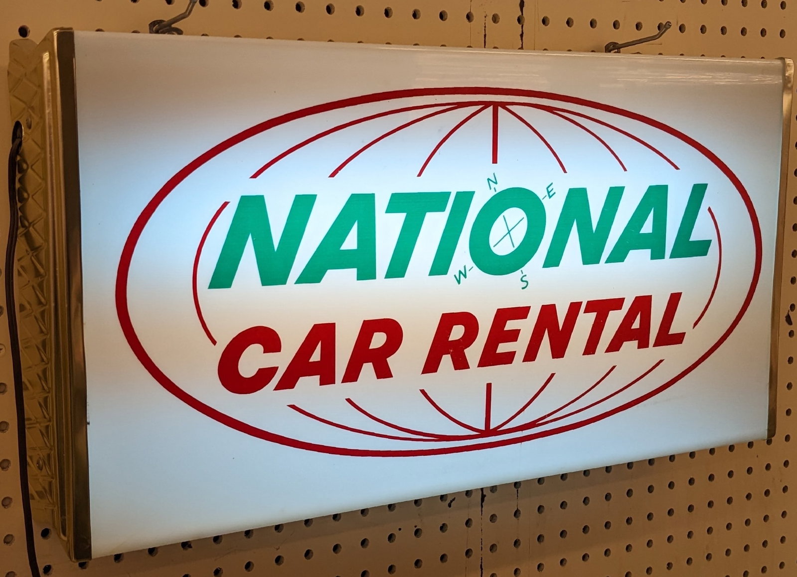 Vintage National Car Rental Lighted Sign: Vintage National Car Rental Lighted advertising sign by Tel-A-Sign. Appears to be in nice working condition with some scratches and wear from use and age. Measures approximately 24in across by the 12i