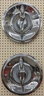 Art Deco Style Nude Lady Chrome Hubcaps: Lot of two Art Deco style nude lady chrome hub caps. Appear to be in good condition with some surface rust and wear form use. They measure approximately 15in in diameter.