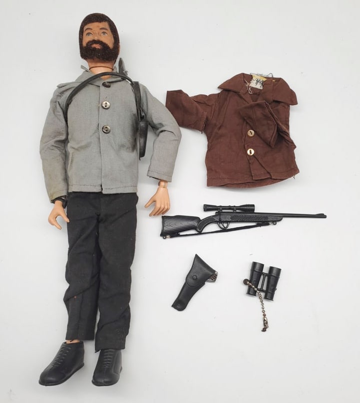 Vintage G. I. Joe Action Figure with Fuzzy Hair and Beard: The G.I. Joe action figure is in good condition. There are cracks on the knees.? Comes with extra accessories and there is discoloration on the clothing.