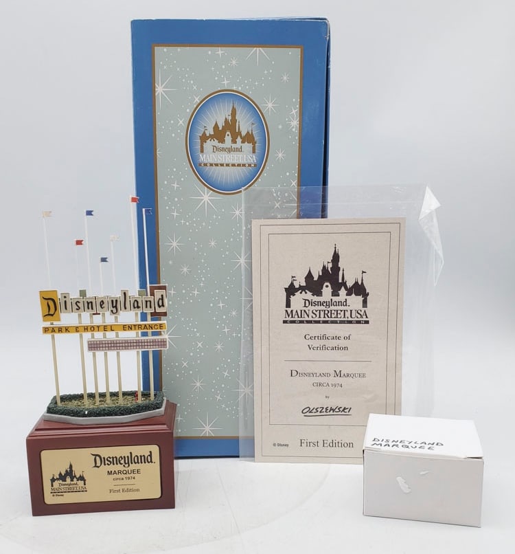 Disney Parks Olszewski First Edition Disneyland Marquee: Marquee Measures 8 1/4” H x 3 3/4” W x 2 1/4” D. Marquee appears to be in overall good condition with original box. Box is in overall good condition with corner damage.