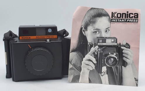 Konica Instant Press Polaroid Camera: The camera looks to be in very good condition and still has some film. It has not been tested. The lens is a Konica Hexanon 110mm 1:4. Comes with instruction manual.
