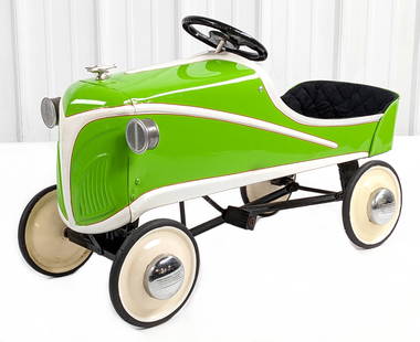 Restored Steelcraft Ace Roadster Pedal Car: Custom restored Steelcraft Ace Roadster pedal car. The car has a custom airplane hood ornament, upholstered interior, and chrome hubcaps. The car has some paint streaks, pitting to the steering