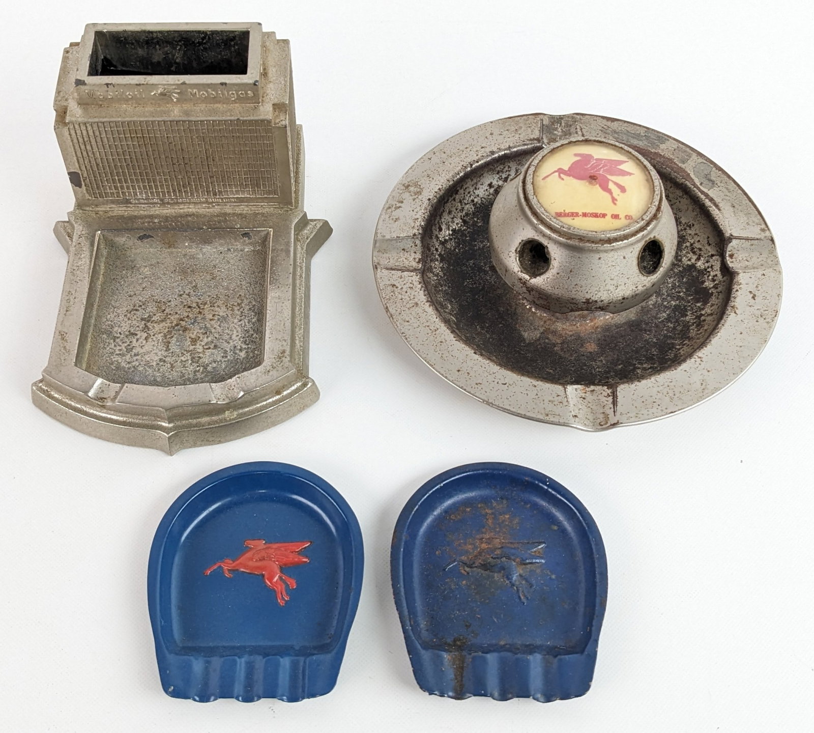 (4) Vintage Mobil Service Station Promotional Ashtrays: Lot of four vintage metal Mobil service station promotional advertising ashtrays. They vary in age and condition with pitting, plate loss, paint loss, and other wear from use and age. The largest meas