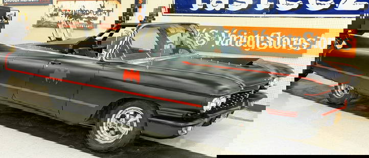 Batty Caddy Batmobile 1960 Cadillac Custom: Car has a very sleek matte black paint job with the red Batman symbols, custom built triangular hood scoop, three exhaust stacks behind the seats, and even a deployable prop gatling gun in the