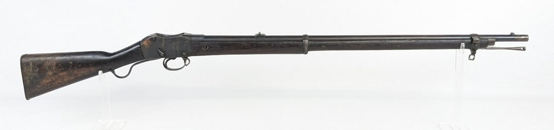 Martini Henry Mk IV .577/450 Falling Block Rifle: The receiver, barrel, and other parts and hardware are all stamped with various English proof marks and other stamps. The stock also has many visible stamps with a painted arsenal marking on the left