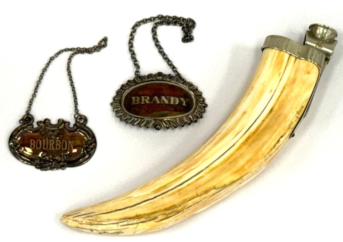 German Sterling Boar Tusk Cigar Cutter & Sterling "Brandy" & "Bourbon" Decanter Labels: German Sterling Boar Tusk Cigar Cutter & Sterling "Brandy" & "Bourbon" Decanter Labels. The boar tusk lighter measures 7.5in long and has German Sterling Marking.? The decanter labels measure approxim