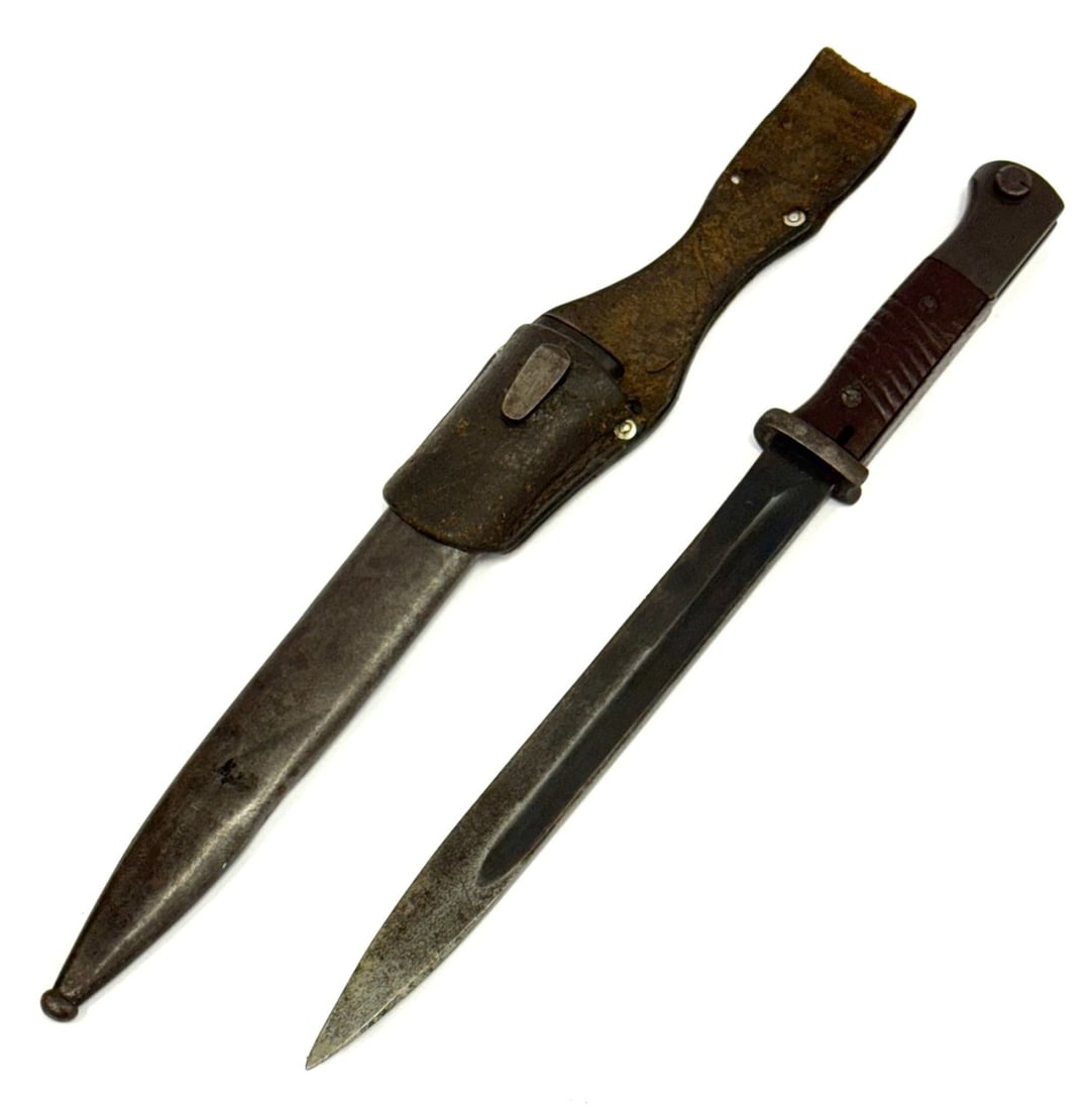 German WW II Bayonet 44ffc Number 5700 With Matching Scabbard: German WW II Bayonet 44ffc Number 5700 With Matching Scabbard. Blade in Very Nice Condition With Nice Patina on Scabbard. Blade Length is 9 3/4".? Overall Length with Scabbard is 15 3/4"